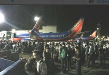 Passengers are standing on tarmac after evacuation at the Los Angeles International Airport. (Source: Twitter)